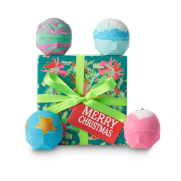 Merry Christmas. A green, wrapped gift box with four Christmas bath bombs around the edge. 