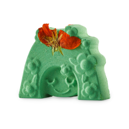 Mother Nature. A bright, nature-green bath bomb in the shape of a face with flower-filled hair and a real fried flower on top.