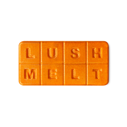 Pumpkin Spice. A rectangle wax melt in a vibrant, sparkly orange colour with 8 segments spelling out "LUSH MELT"
