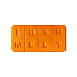 Pumpkin Spice. A rectangular wax melt in a vibrant, sparkly orange colour with 8, equal segments spelling out "LUSH MELT"