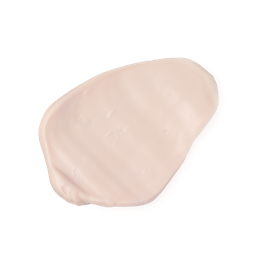 A creamy, pale pink swatch of LUSH Rebel body lotion or cosmetic product, smoothed onto a light grey background. The texture is thick and glossy.