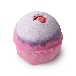 Sex Bomb. A round bath bomb, with a lilac top and a pink base, finished with a pink, rice paper rose crowning the bath bomb.