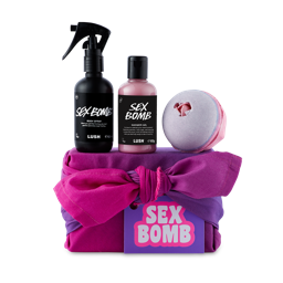 Sex Bomb. A pink and purple, fabric-wrapped gift box with 3 Sex Bomb products sat on top. 