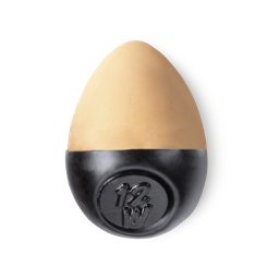 Slap Stick 12W. A medium light-warm, warm, yellowy beige coloured, egg-shaped solid foundation, with a black wax base.