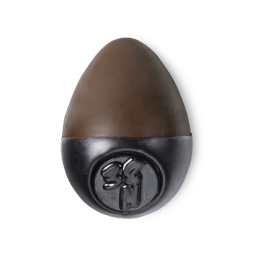Slap Stick 38N. A dark-neutral, dark chocolate brown, egg-shaped solid foundation, with a black wax base.