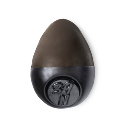 Slap Stick 39N. A dark-neutral, dark chocolate brown, egg-shaped solid foundation, with a black wax base.