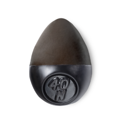 Slap Stick 40N. A dark-neutral, dark chocolate brown, egg-shaped solid foundation, with a black wax base.