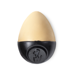 Slap Stick 9W. A light-warm, yellowy, warm beige coloured, egg-shaped solid foundation, with a black wax base.