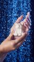 A close-up show of the model's hands lathering up creamy suds with the Snow Bear soap under shower water. 