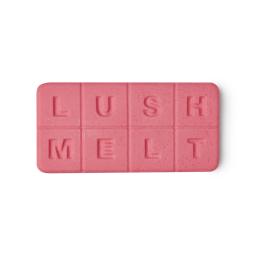 Snow Fairy. An oblong, bright pink wax melt sectioned into 8 squares spelling "LUSH MELT".