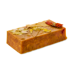 Sticky Syrup. A golden, caramel-coloured slab or rectangle soap with pressed, dried flowers on top. 