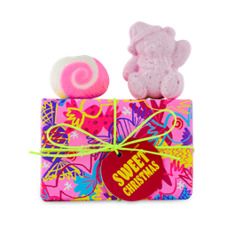 Sweet Christmas. A vibrantly wrapped gift box with Butterbear bath bomb and mini Snow Fairy Roll bubble bar on top.