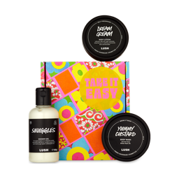 The image shows a brightly printed gift box with three Lush products around the edge. 