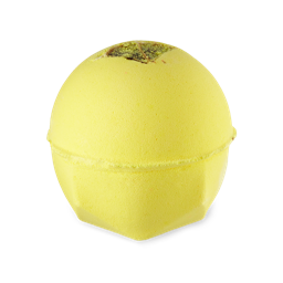 The One With Lemon Oil. A classic LUSH shaped bath bomb in a vibrant, canary yellow with a dried lemon slide embedded on top. 