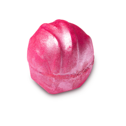 Think Pink. A round, very much pink bath bomb, complete with a silver shimmer coating and a fabric ripple-like design on top.