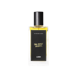 A glass perfume bottle filled with canary yellow liquid. A black label reads 'The Perfume Library' and 'Two More Hearts'.