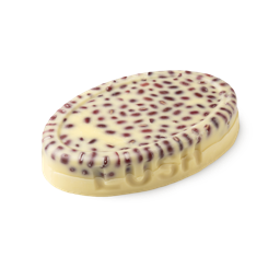 Wiccy Magic Muscles. A buttery yellow, oval shaped, solid massage oil bar, with LUSH imprinted on its edge, 