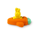 The Flying Carrot, a little yellow bunny bath bomb sits inside an orange carrot bath bomb that's in the shape of a plane.